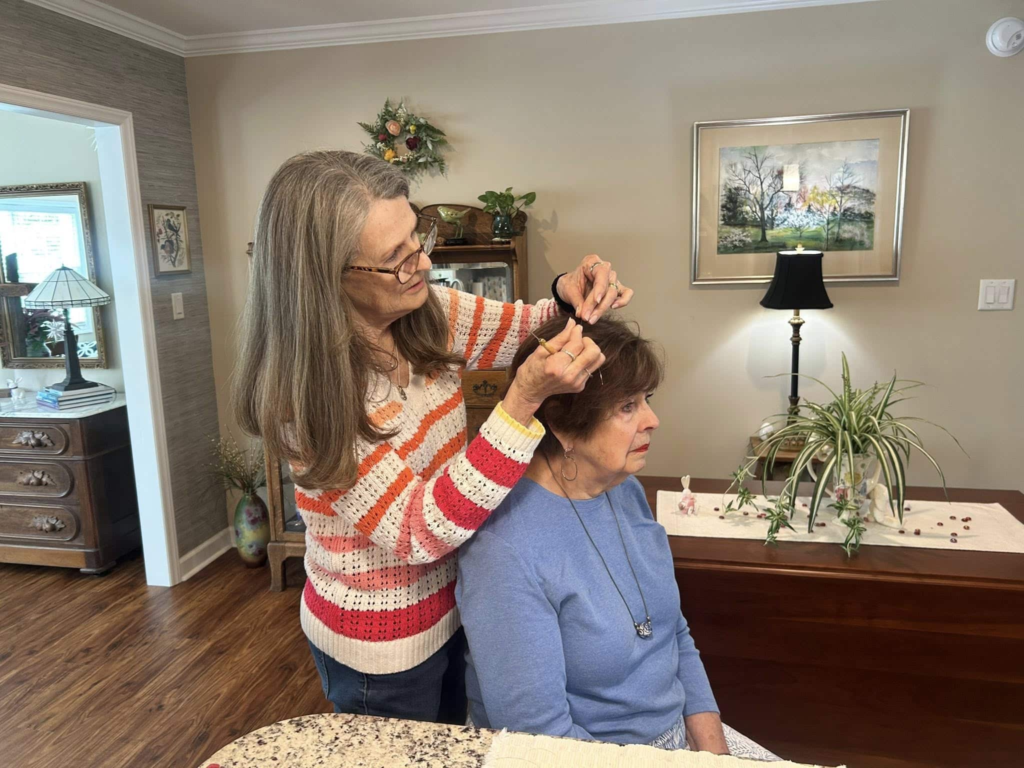 661302734 1890782725202405 1636907300157869378 n Senior living resident styling her sister’s hair at Sunnyside Communities